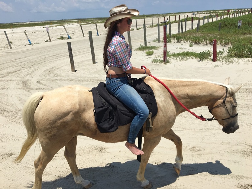 Young woman riding a horse