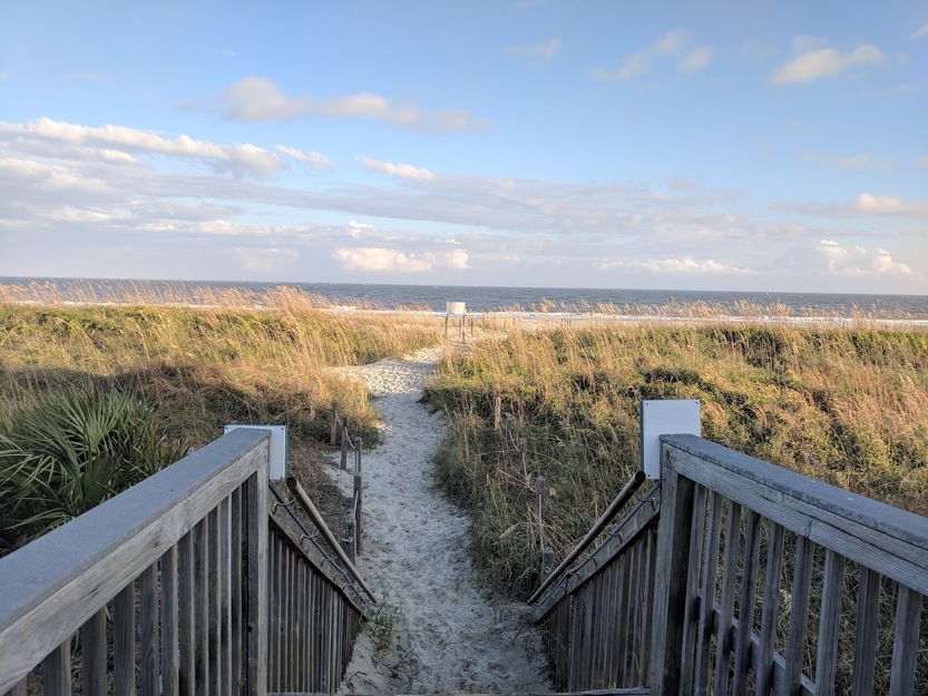 Wooden stairs and sandy beach entrance