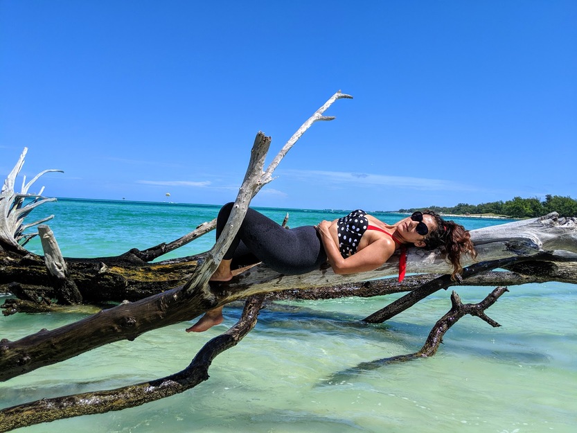 Woman lying on driftwood