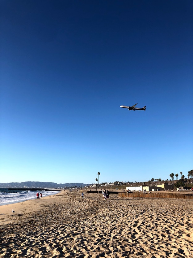 Plane flying over Dockweiler Beach California