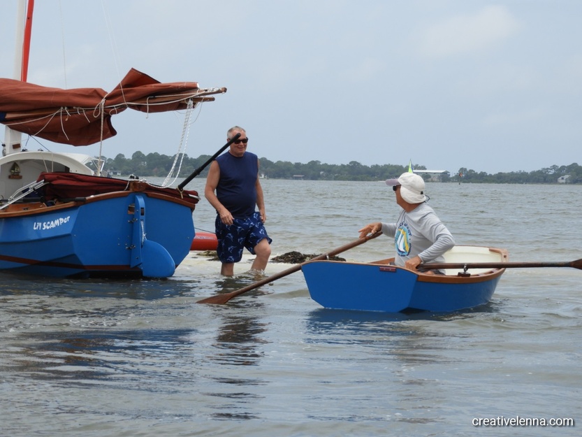 People sailing by boats to Atsena Otie Key Beach, FL