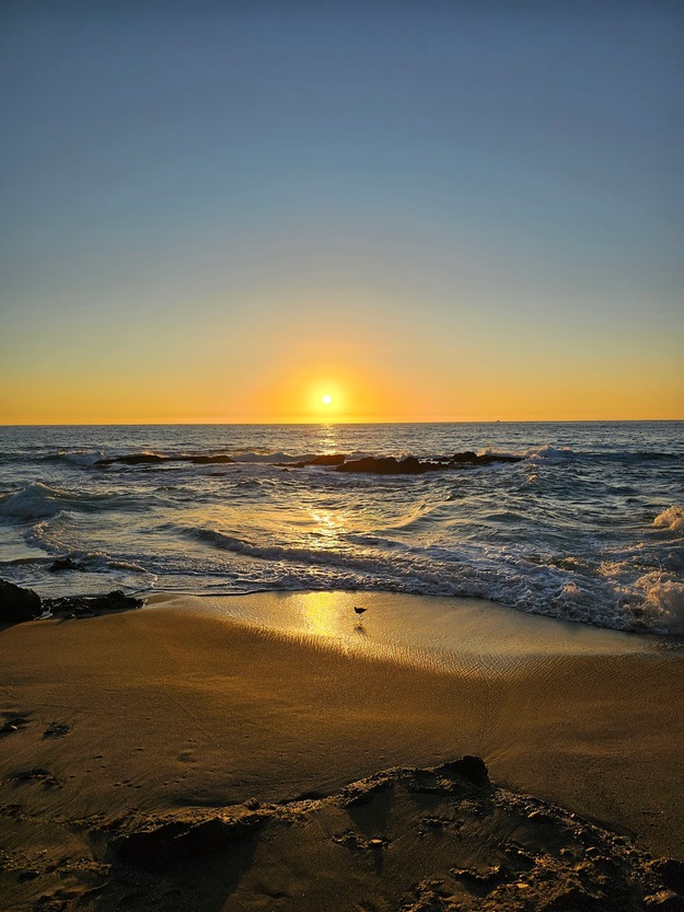 Sun rising over Victoria Beach, Laguna Beach, California