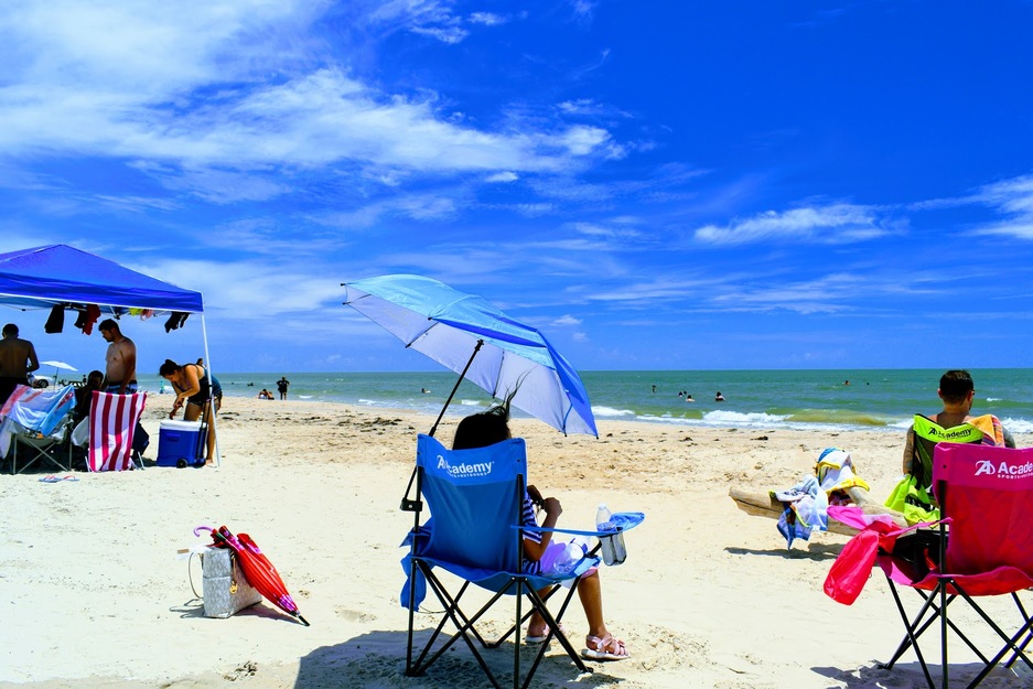 Woman relaxing in an armchair on Surfside Beach