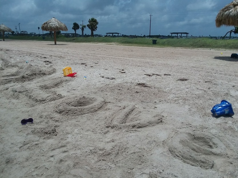 The word 'love' written on the sand